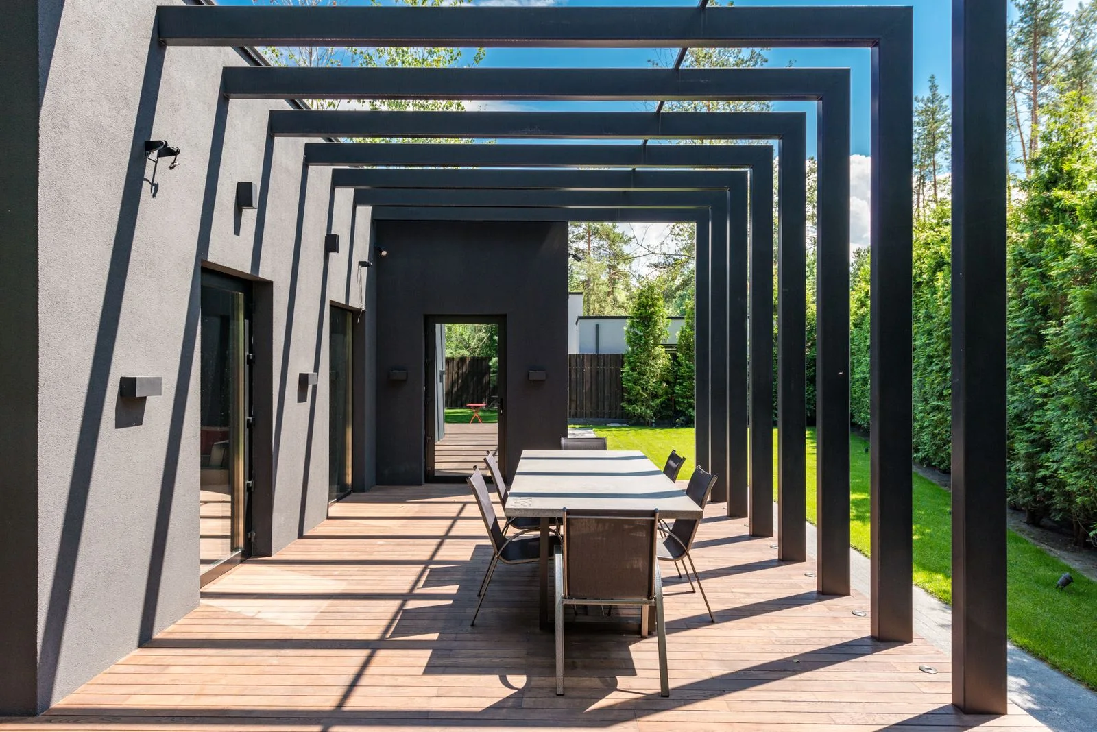 A pergola framing an outdoor garden living area